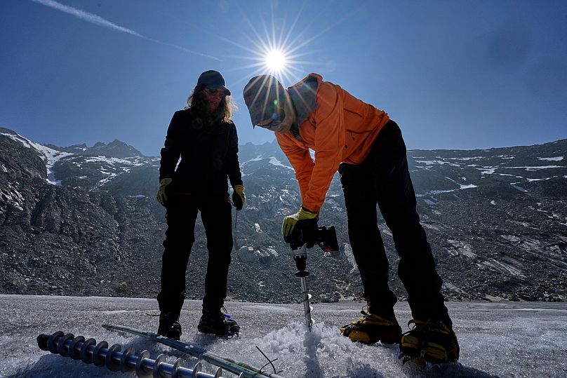 Matthias Huss, of the Federal Institute of Technology in Zurich and glacier monitoring group GLAMOS, drills holes into the Rhone Glacier .