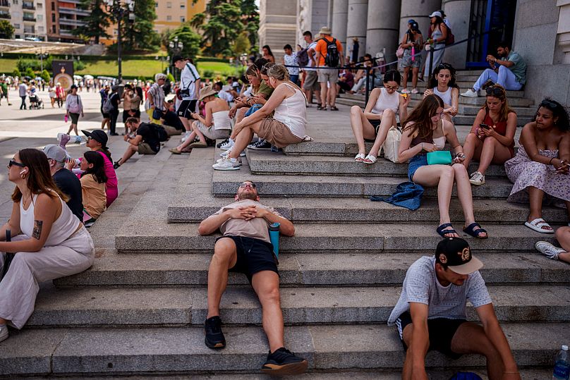 People rest during a hot and sunny day of summer in Madrid, Spain, Wednesday, July 19, 2023