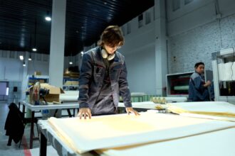 Εργαζόμενοι σε μονάδα παραγωγής εξετάζουν υλικά